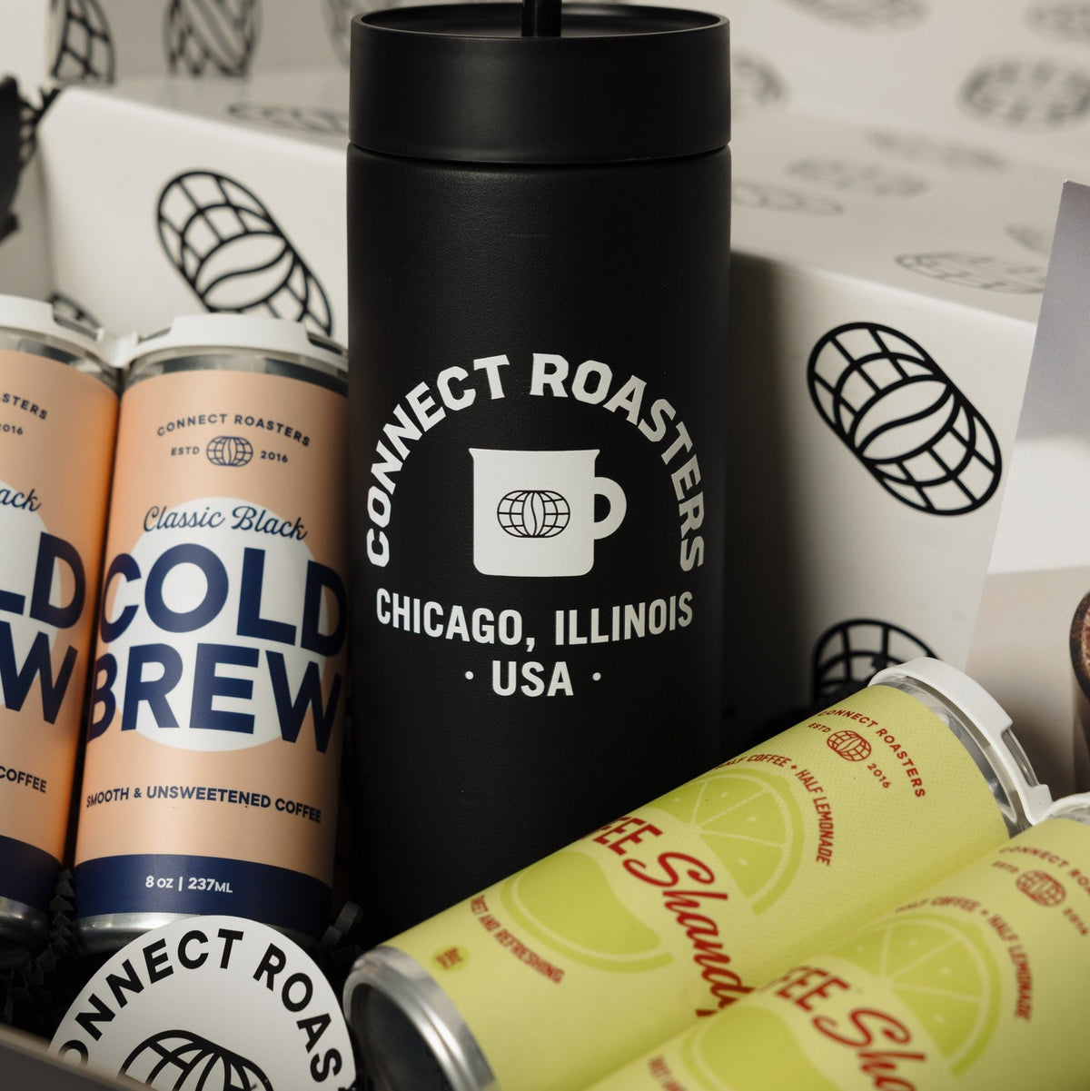 Close view of the Cold Case tumbler with cold brew and Coffee Shandy cans
