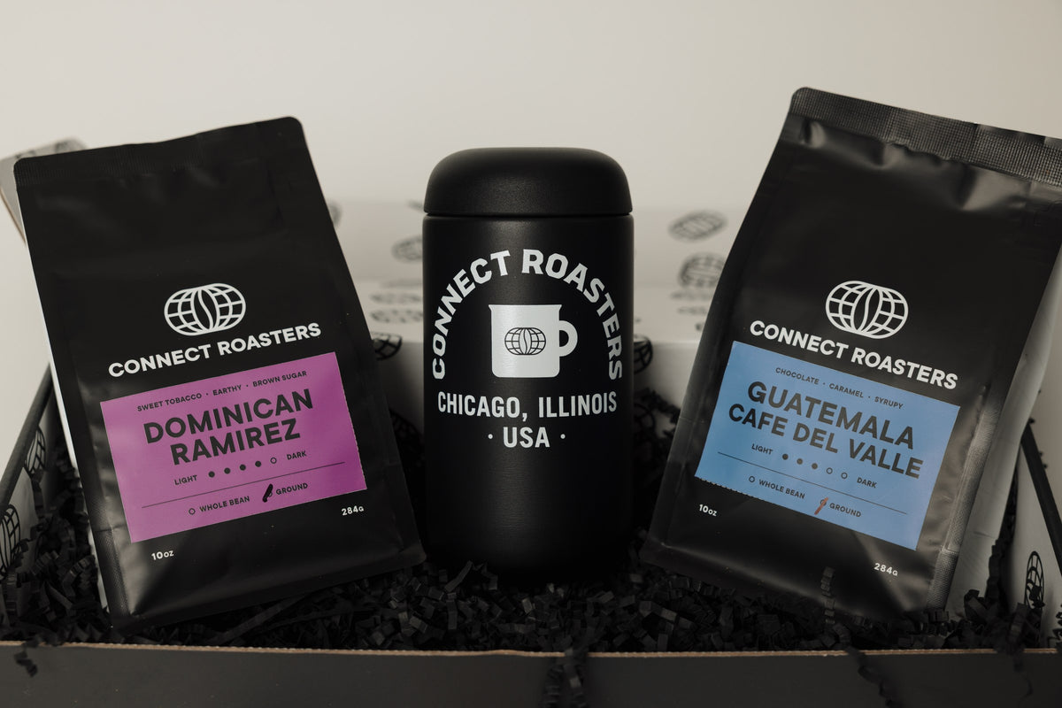 An open Connect Roasters gift box with two bags of coffee and an insulated travel mug